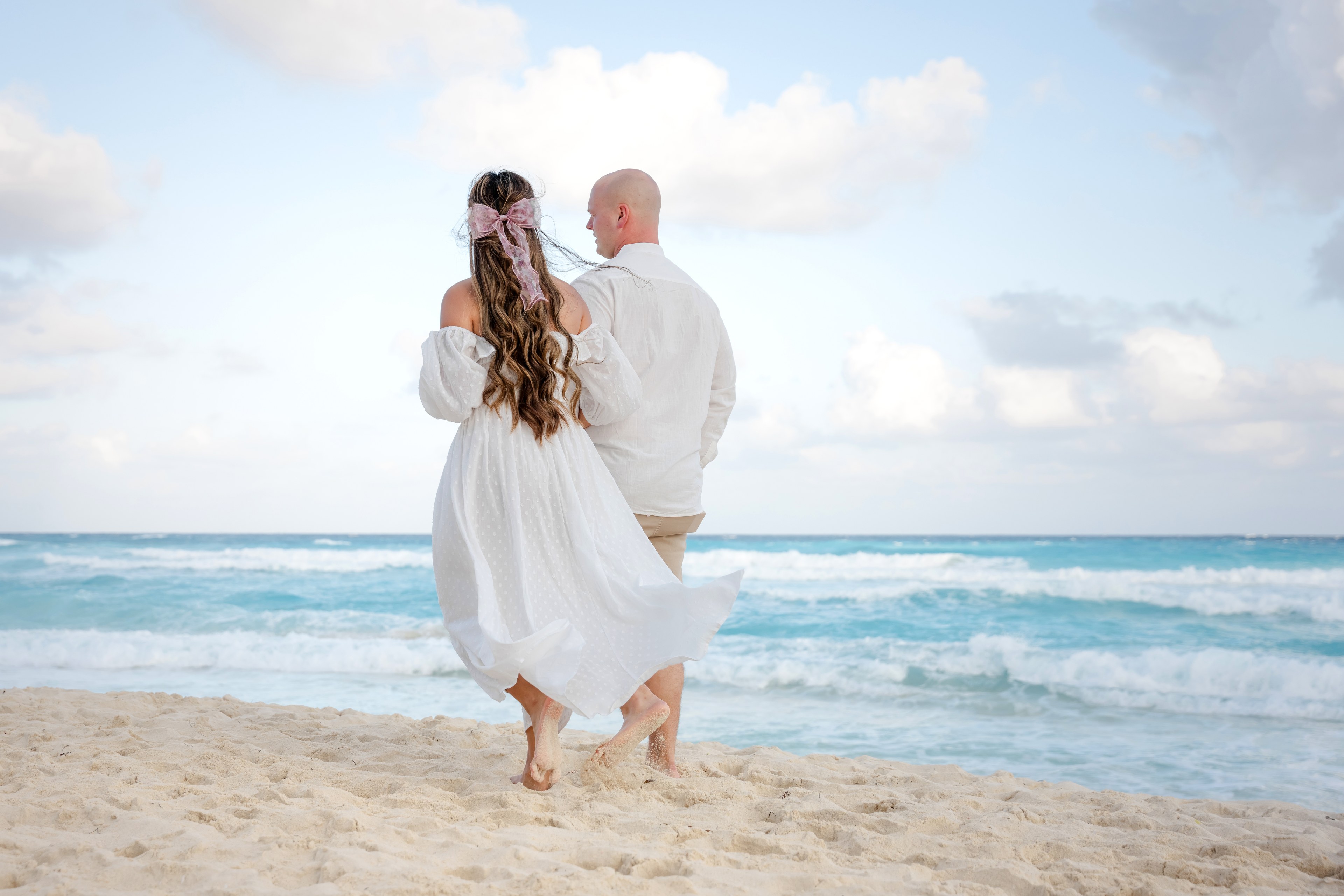 Couple at golden hour on a Cancun beach, photographed by IVAE Studios