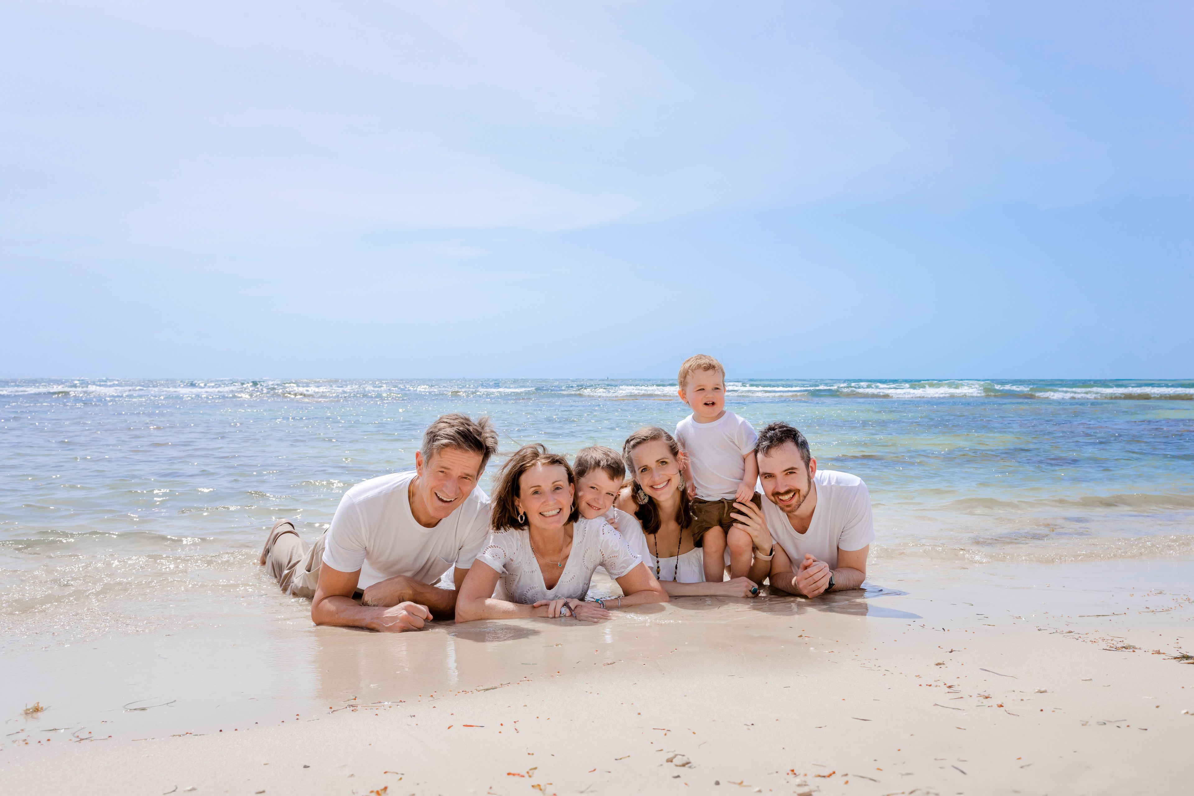 Family hands joined in shallow water