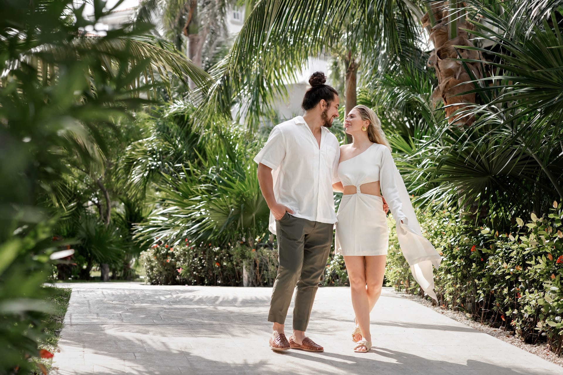 Couple on a Cancun beach at golden hour, IVAE Studios