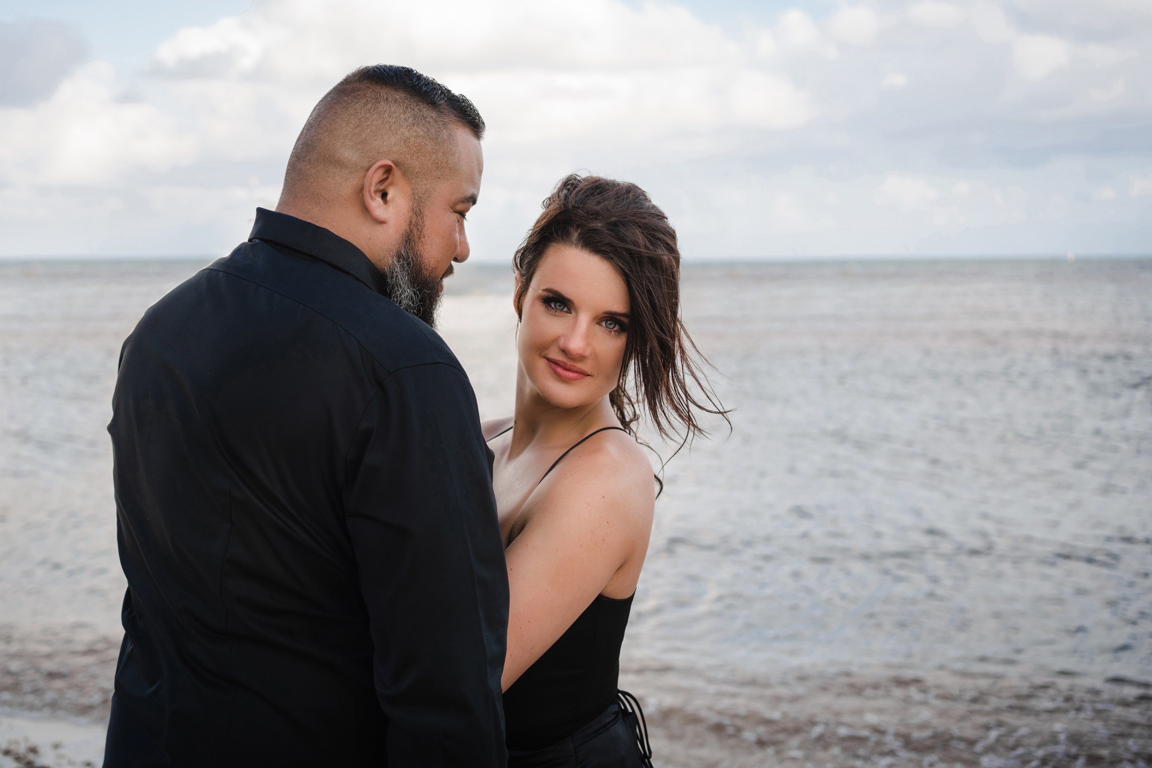 Bride on the Cancún coastline during a luxury wedding session at golden hour